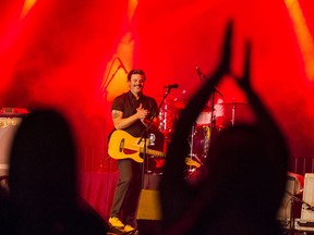 A member of the crowd claps alongside Jay Malinowski, lead singer and guitarist for the band Bedouin Soundclash, as the band performs onstage Saturday night at the recently opened Base31 concert venue near Picton, Ontario. ALEX FILIPE