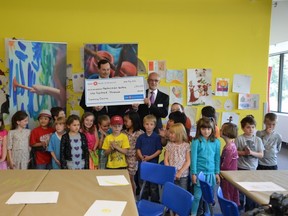 A touring school group at the MacKenize Art Gallery from École St. Andrews elementary school helps celebrate BMO Financial Group’s gift of $100,000 with Mike Darling, District Vice President - Saskatchewan, BMO Bank of Montreal and Jeremy Morgan, Executive Director, MacKenzie Art Gallery.
