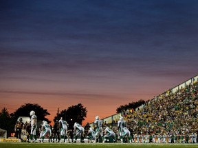 The Roughriders rose as the sun set on Ivor Wynne Stadium on Friday night (THE CANADIAN PRESS/ Geoff Robins)