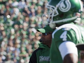 Riders head coach Corey Chamblin (back) said Darian Durant (4) suffered just a strained hip flexor on Sunday and should be OK (THE CANADIAN PRESS/Liam Richards)