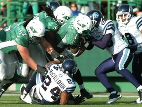 Running back Kory Sheets (1) had help from Brendon LaBatte (57) and Xavier Fulton on this touchdown run Saturday (MICHAEL BELL/Leader-Post)