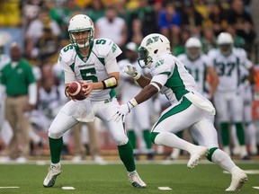 Drew Willy and Kory Sheets helped the Riders sweep the Tiger-Cats on Saturday (THE CANADIAN PRESS/Geoff Robins).