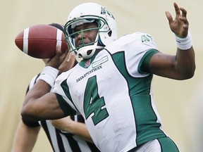 Darian Durant (4) spent a lot of time in the grasp of the Blue Bombers on Sunday
(THE CANADIAN PRESS/John Woods)