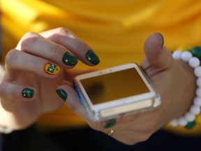 Remember to be courteous when using your smartphone. July is National Cell Phone Courtesy Month (AP Photo/Julio Cortez