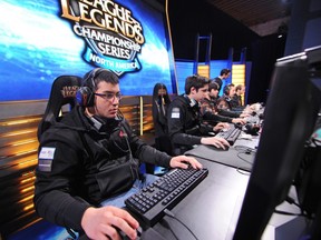 Venezuelan player Diego "Quas" Ruiz (L) of team "Curse", prepares for the start of a match against "Cloud 9" during the League of Legends North American Championship Series Spring round robin competition, at the MBS Media Campus in Manhattan Beach, California on February 22, 2014.  League of Legends is the king of the hot trend in videogame play as a spectator sport, complete with sold-out stadiums and fans camping all night for tickets to matches.        (ROBYN BECK/AFP/Getty Images)