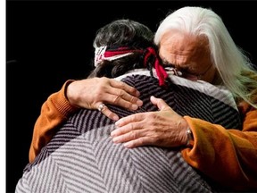 Residential school survivor Joe George, right, of the Tsleil-Waututh First Nation, and elder Marie George embrace during the Truth and Reconciliation Commission of Canada British Columbia National Event in Vancouver, B.C., on Wednesday September 18, 2013. The commission was formed by the Canadian government with a mandate to learn the truth about what happened in the residential schools and to inform the public.
