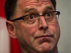 British Columbia NDP leader Adrian Dix listens to a question after announcing he will step down as leader of the party during a news conference in Vancouver, B.C., on Wednesday September 18, 2013.