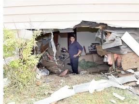 Angelo Coppola inspects damage to his rental house on the 800 block of Rink Avenue in Regina on July 03, 2015 after a car crashed into the basement around 3 a.m. Friday morning. The tenant of the home was not home at the time of the accident.