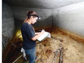 Archaeology PhD student Julie Mushynsky is exploring the bomb shelter in Gail Bowen´s back yard in Regina on Saturday.