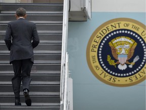 President Barack Obama walks up the stairs to board Air Force One before leaving from O'Hare International Airport in Chicago, Wednesday Oct. 28, 2015, heading back to Washingon.