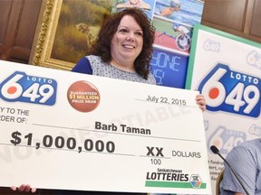 Barbara Taman of Moose Jaw won holds up a $1,000,000 cheque she won on LOTTO 649.