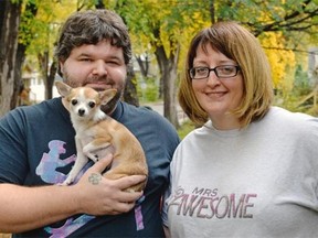 Wes and Bernadette Awesome pose with their dog Chicken Nugget outside their home in Regina, Sask. on Sunday Oct. 4, 2015. Wes changed his last name to Awesome in May 2015, and Bernadette took his last name when they got married in June.