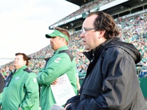 Brendan Taman (R) Vice President of Football Operations and General Manager for the Saskatchewan Roughriders watching the CFL preseason game against the Calgary Stampeders at Mosaic Stadium in Regina on June 19, 2015.