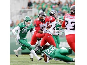 Calgary Stampeders running back Tim Brown (#2) jumps over the tackle of Saskatchewan Roughriders defensive back Don Unamba (#22) during a game held at Mosaic Stadium in Regina, Sask. on Saturday Aug. 22, 2015.