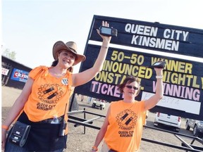 Carmen Knaus (L) and Annette Clute sell 50-50 tickets for the Queen City Kinsmen during the 2015 Craven Country Jamboree on July 10, 2015.