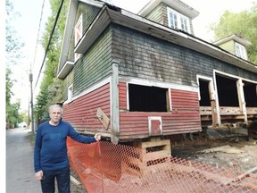 An old carriage house that is currently in the process of being repaired by Regina couple Joe Michel and Tammy Kwan in Regina on August 19, 2015.  Joe Michel is shown in the photo. The carriage house has been lifted as a new foundation is being built for it.