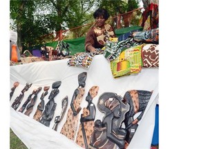 Charity Kumassah manages her African Clothes and Crafts goods Saturday during AfroFest. Hundreds made their way to the festival at Victoria Park to help celebrate African culture.