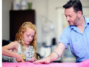 Child fashion designer Raina Haus at works with fashion designer Dean Renwick at his studio in Regina on Wednesday.