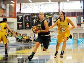 Claire Douglas, left, of Saskatchewan drives against Manitoba’s Jessica Dyck during the female basketball final at the Western Canada Summer Games on Tuesday in Fort McMurray Alta. Saskatchewan won 71-54 to earn the gold medal.