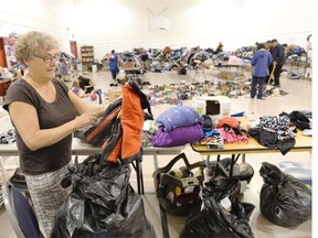 Claudette Bugiera volunteers her time to help sort clothes for evacuees at the Gathering Place in Regina on Thursday.