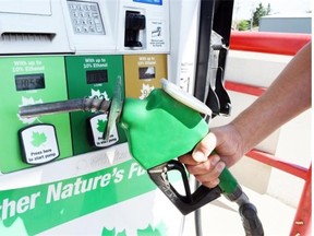 A customer filling up at the Husky Gas Bar on Park Street in Regina recently. Service station sales were down 14.5 per cent year-over-year in June due to falling oil prices.