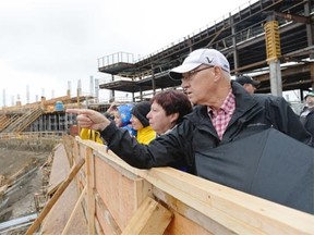 Dennis Butler, right, points at the construction at a “sneak peekÓ day held at the new stadium in Regina, Sask. on Saturday Sep. 5, 2015.