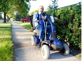 Doug Ottenbreit, NDP candidate for Yorkton-Melville, canvassing in Melville on Aug. 24, 2015. Ottenbreit has cerebral palsy, so canvassing for him can require a bit more work. (BRYAN SCHLOSSER/Regina Leader-Post)