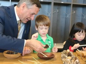 Education Minister Don Morgan does crafts with children at the Awasis Child Care Centre on Sept. 18, 2015.
