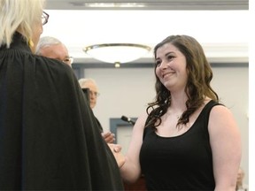 Erin Pippin (right) steps forward to receive a gold life-saving award from Vaughn Solomon Schofield (left) during the St. John Ambulance´s Life-Saving awards held at Government House in Regina on Saturday June 20, 2015. Pippin was honoured for helping people who were injured during a stabbing incident at the Cornwall Centre in April 2014.