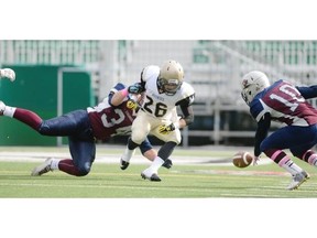 Ethan Hautz, left, of the Regina Thunder strips the ball from the Edmonton Huskies’ Landon Rosene, 26, while the Thunder’s  Marcus Hall, right, attempts to recover the loose pigskin Sunday at Mosaic Stadium.