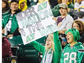 Fans of the Saskatchewan Roughriders cheer on their team during a CFL game at Commonwealth Stadium on September 26, 2014 in Edmonton, Alberta, Canada.