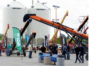 Farmers check out equipment at Canada’s Farm Progress show in Regina in June. Statistics Canada says machinery and equipment sales were down nine per cent year over year in May. (BRYAN SCHLOSSER/Leader-Post.)