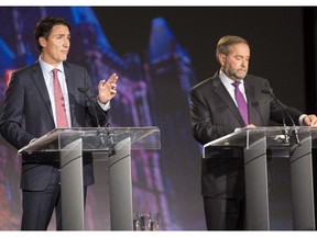 Liberal leader Justin Trudeau, left, and New Democratic leader Thomas Mulcair, centre, during the Globe and Mail Leader's Debate 2015 in Calgary, on September 17, 2015.