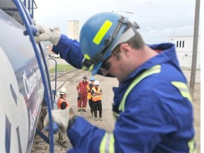 First responders from Moose Jaw and Regina check out the TRANSCEAR railway car, which used to hold dangerous goods. the inside of the car now offers information and tools for first responders to use to familiarize themselves with the railway.