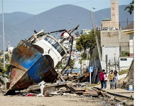 A fishing boat that was ran aground by the sea while moored in the port of Coquimbo, some 445 km north of Santiago, during the eve’s earthquake on September 17, 2015. A million people were evacuated in Chile after an 8.3-magnitude quake struck offshore in the Pacific, killing at least 10 people and triggering tsunami waves along its northern coast.