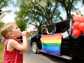 Four-year-old Alex Christbason blows on a horn as a float passes by during the Queen City Pride parade in Regina on Saturday June 20, 2015.