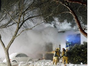 The front window lies broken in the front yard at the scene of an explosion and fire at a home at 152 Cooper Cres. in the city’s northwest in February.