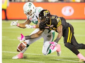 Ed Gainey of the Hamilton Tiger-Cats, right, battles for a loose ball with the Saskatchewan Roughriders’ Spencer Moore on Oct. 9, 2015 after blocking a punt at Tim Hortons Field. The blocked punt set up a touchdown that helped Hamilton win 30-15.