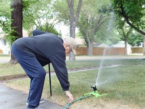 Garry Matthyssen started watering his lawn for the first time today since the city of Regina volunteer watering guidelines were suspended in Regina. (DON HEALY/LEADER POST)