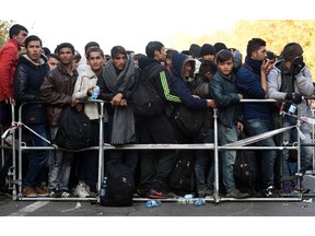 Migrants wait to cross the Austrian-German border near the Bavarian village Passau, southern Germany, on October 28, 2015. AFP PHTO / CHRISTOF STACHECHRISTOF STACHE/AFP/Getty Images