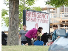 A group of families stands near the Credit Union EventPlex in Regina on Sunday July 12, 2015.