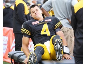 Hamilton Tiger-Cats quarterback Zach Collaros (4) grimaces while trying to lift himself off of the trainers table during the first half of CFL football action in Hamilton, Ontario against the Edmonton Eskimos on Saturday, September 19, 2015. Collaros left the game after getting injured and did not return during the first half.