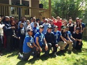 High school students and their families filled the lawn at 1409 Rae St. — site of one of the newest Habitat for Humanity homes in Regina.