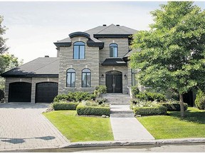 AFTER: Reducing the size of the driveway and adding plantings to the front improved the homes entrance.