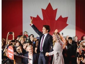 Incoming prime minister Justin Trudeau, left, and his wife Sophie Gregoire greet supporters as they arrive at Liberal party headquarters in Montreal, early Tuesday morning, October 20, 2015.