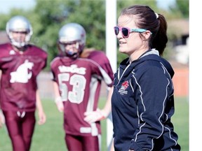 Johnson Wildcats defensive line coach Emma Hicks, right, is believed to be the first female football coach in Regina high school football history.