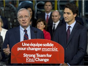 Liberal leader Justin Trudeau stands next to former prime minister Paul Martin as he addresses supporters Friday in Montreal. THE CANADIAN PRESS/Paul Chiasson