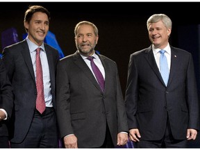 Liberal leader Justin Trudeau, left, NDP leader Tom Mulcair and Conservative leader Stephen Harper, right pose for photos before the Globe and Mail hosted leaders debate Thursday, September 17, 2015  in Calgary.THE CANADIAN PRESS/Ryan Remiorz