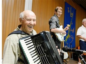 Karl Weisbrod, 91, laughs on stage while Gary Harty, center, and Pat Mulvay, right, look on during an accordion festival held at Our Lady of Peace Church in Regina on Sunday August 16, 2015.