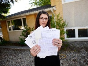 Kaylee Bellegarde holds up receipts from a contractor  in Regina on Tuesday.